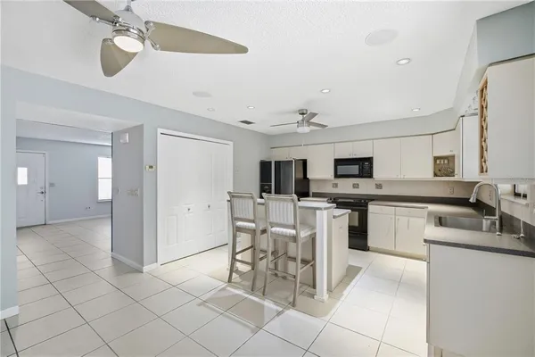 a kitchen with a sink stove and microwave