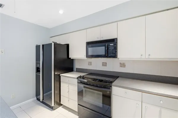 a kitchen with stainless steel appliances a refrigerator and a stove
