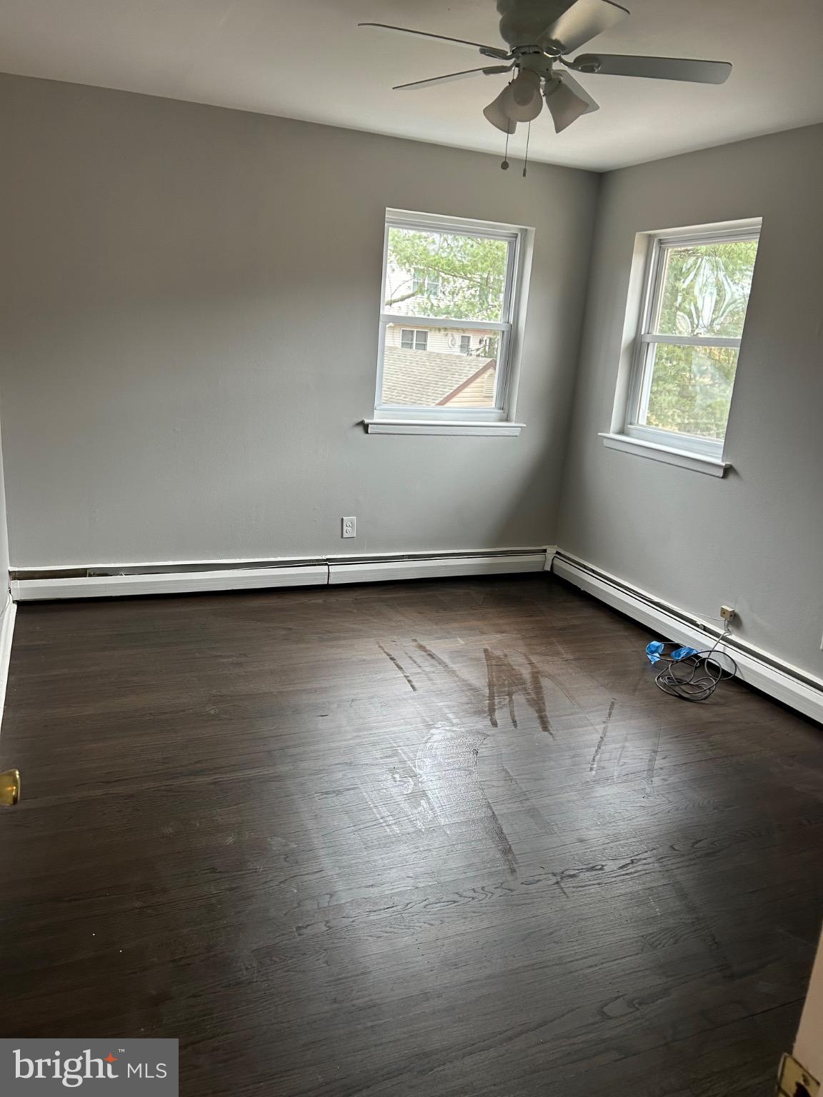 839 Garrett Road Springfield, PA 19064 - Photo 11 of 20 an empty room with wooden floor and windows