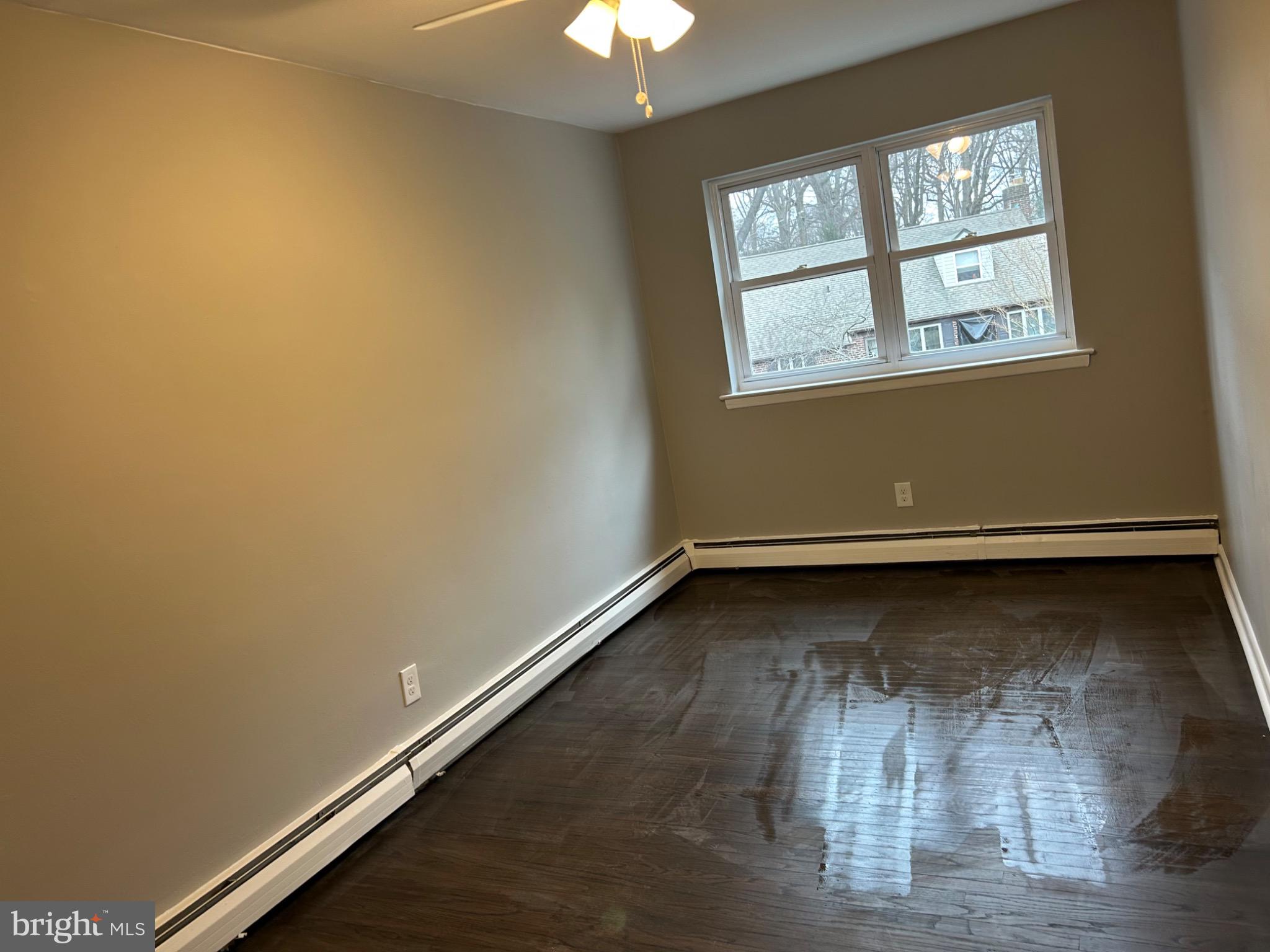 839 Garrett Road Springfield, PA 19064 - Photo 12 of 20 an empty room with wooden floor and windows