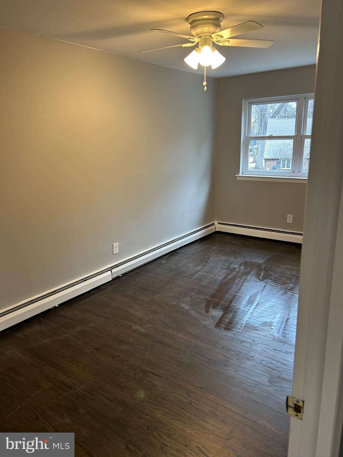 839 Garrett Road Springfield, PA 19064 - Photo 13 of 20 an empty room with wooden floor and windows