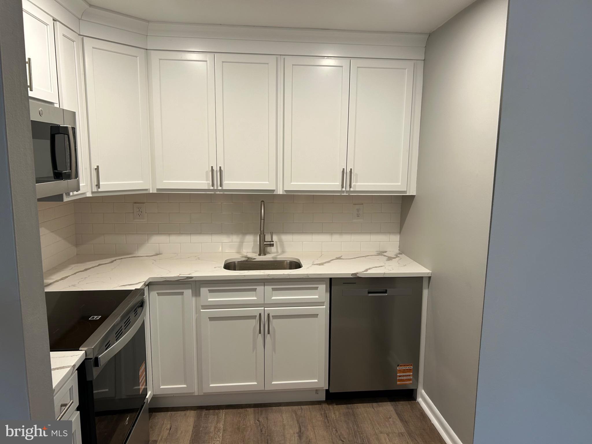 839 Garrett Road Springfield, PA 19064 - Photo 20 of 20 a view of cabinets a sink and a stove in a kitchen