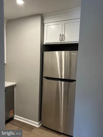 a view of a room with wooden floor