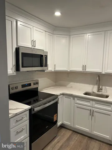 a kitchen with a sink stove and microwave