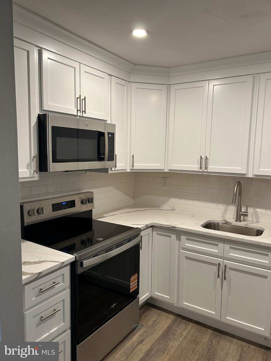839 Garrett Road Springfield, PA 19064 - Photo 5 of 20 a kitchen with a sink stove and microwave