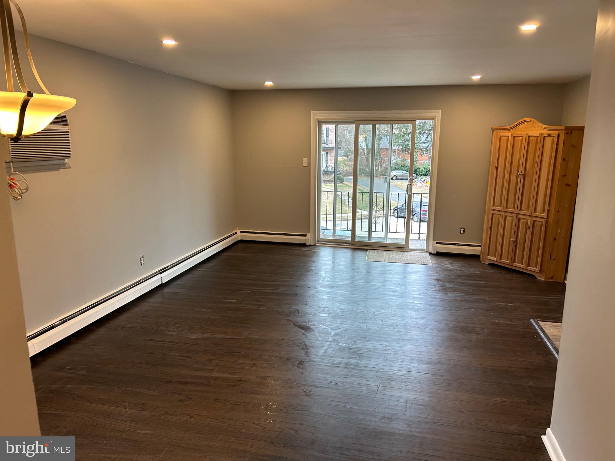 839 Garrett Road Springfield, PA 19064 - Photo 6 of 20 an empty room with wooden floor and windows