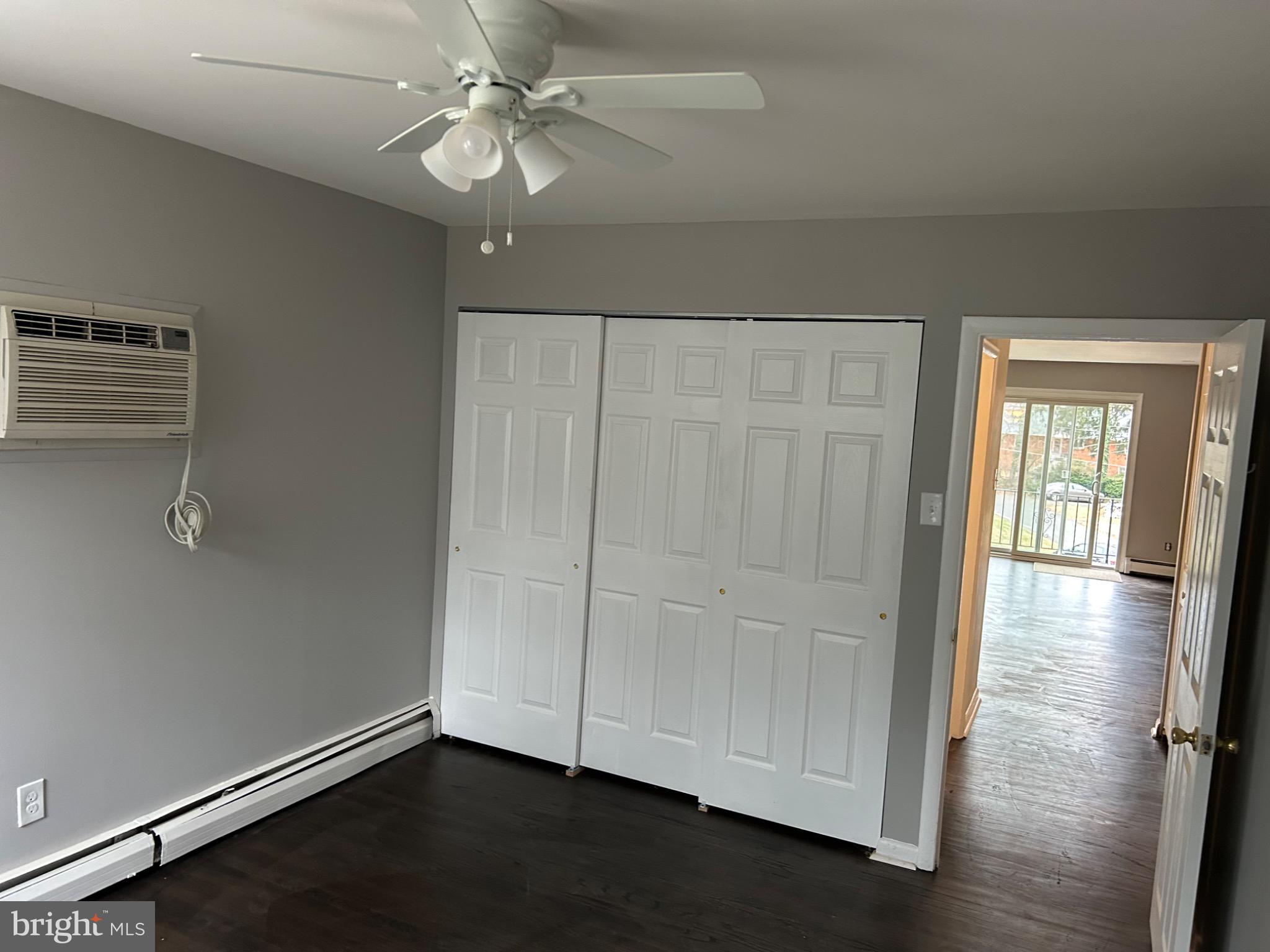 839 Garrett Road Springfield, PA 19064 - Photo 8 of 20 an empty room with wooden floor cabinet and windows