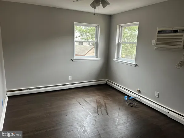 a view of a room with wooden floor and window