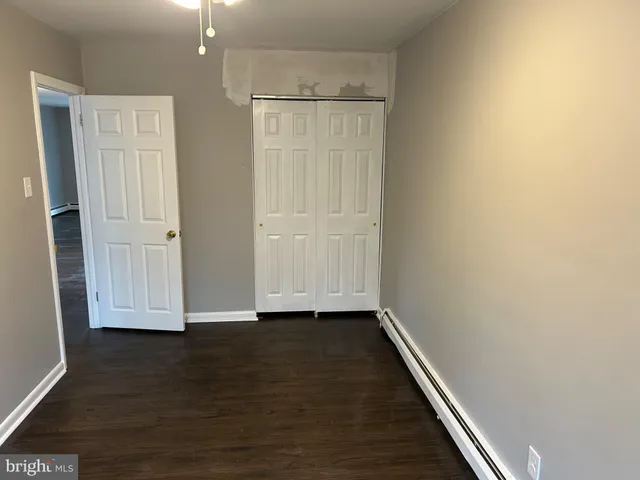 an empty room with wooden floor