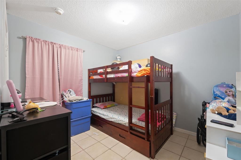 4917 18th Street Zephyrhills, FL 33542 - Photo 13 of 16 a bedroom with furniture and a bathtub