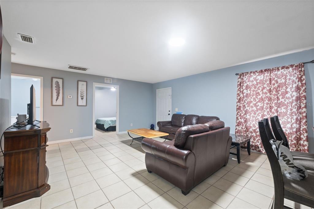 4917 18th Street Zephyrhills, FL 33542 - Photo 7 of 16 a living room with furniture and a flat screen tv
