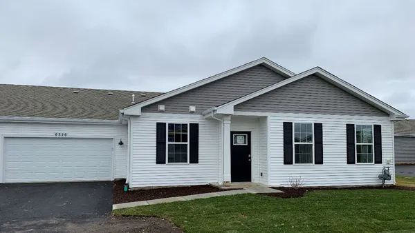 a view of house with a yard