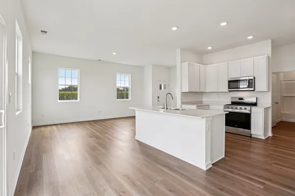 a kitchen with wooden floors and white appliances