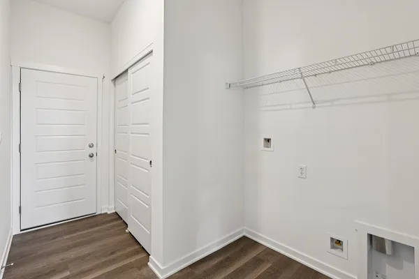 a view of a room with wooden floor