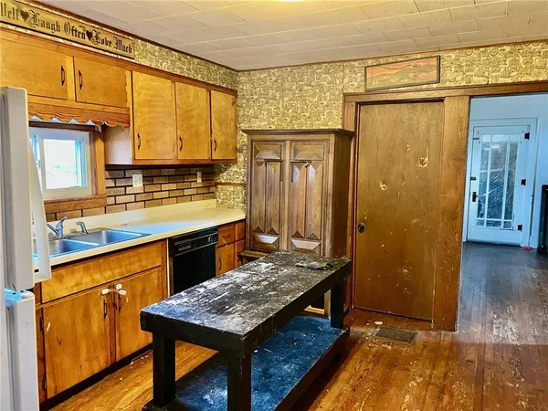 a kitchen with a refrigerator a sink and a stove