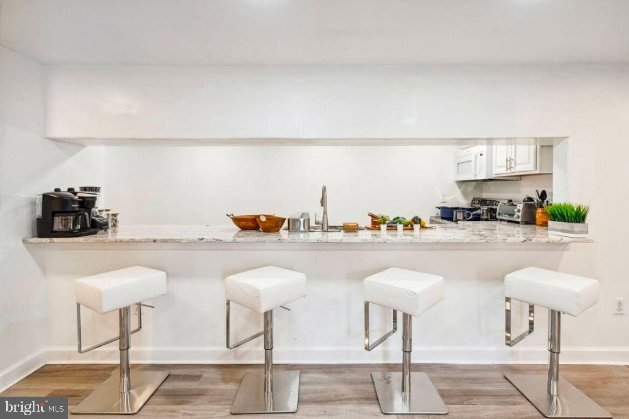 311 Old Rodgers Road Bristol, PA 19007 - Photo 4 of 9 a kitchen with a sink and chairs