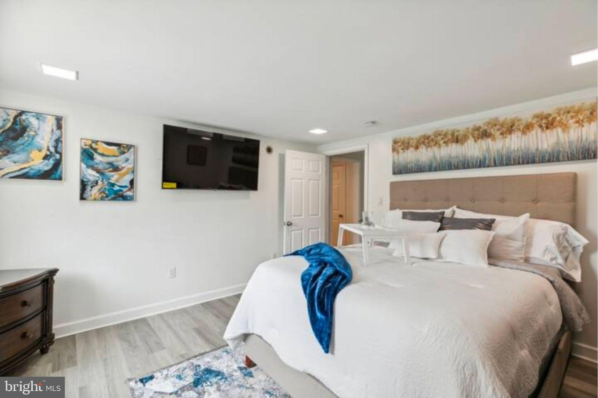 311 Old Rodgers Road Bristol, PA 19007 - Photo 8 of 9 a bedroom with a bed and a flat screen tv