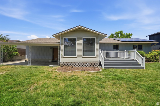 392 Perrine Drive Midvale, UT 84047 - Photo 36 of 37 Backyard with deck and covered patio.