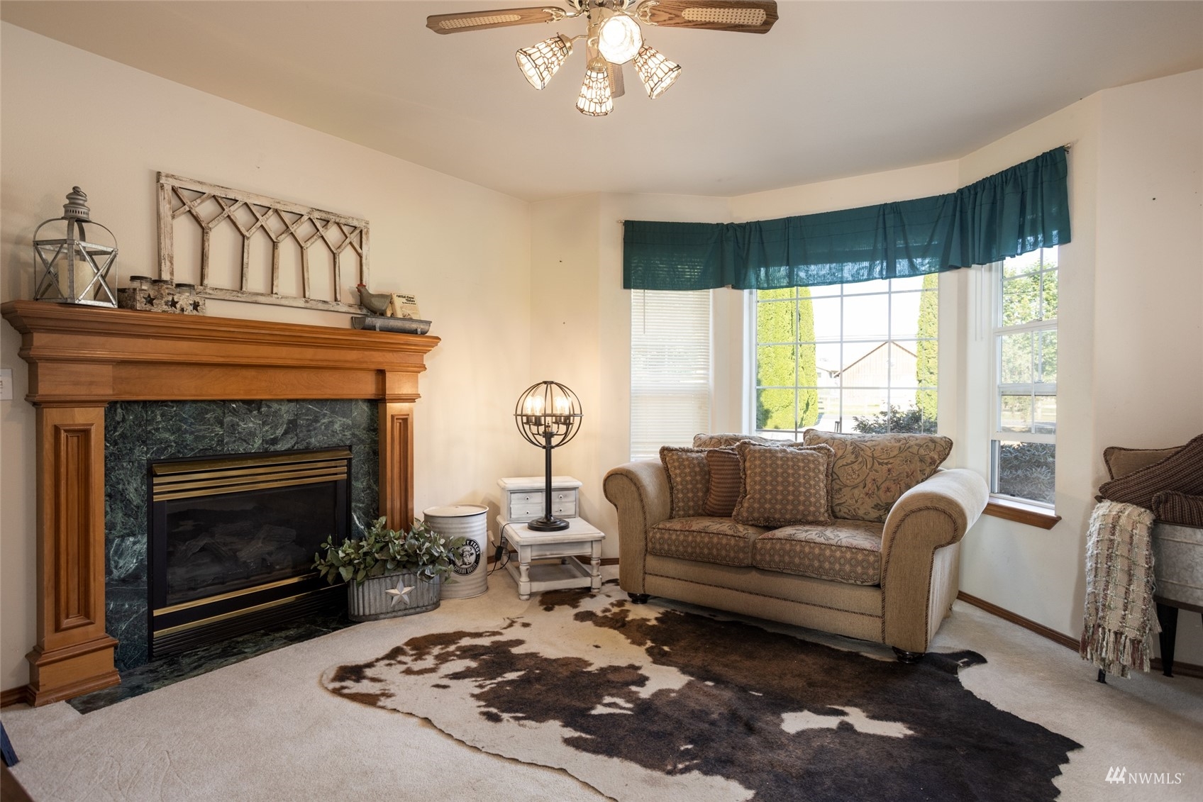 15606 Beaver Marsh Road Mount Vernon, WA 98273 - Photo 12 of 39 a living room with furniture a fireplace and a large window