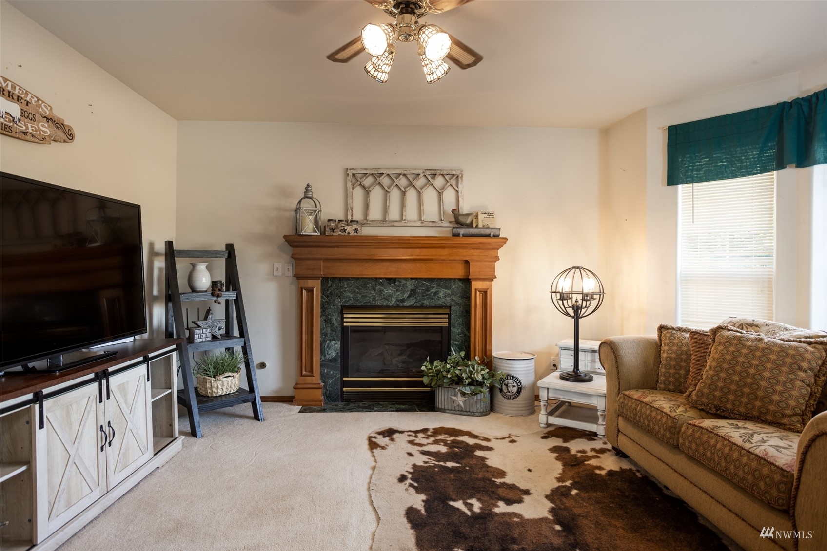 15606 Beaver Marsh Road Mount Vernon, WA 98273 - Photo 13 of 39 a living room with furniture a flat screen tv and a fireplace