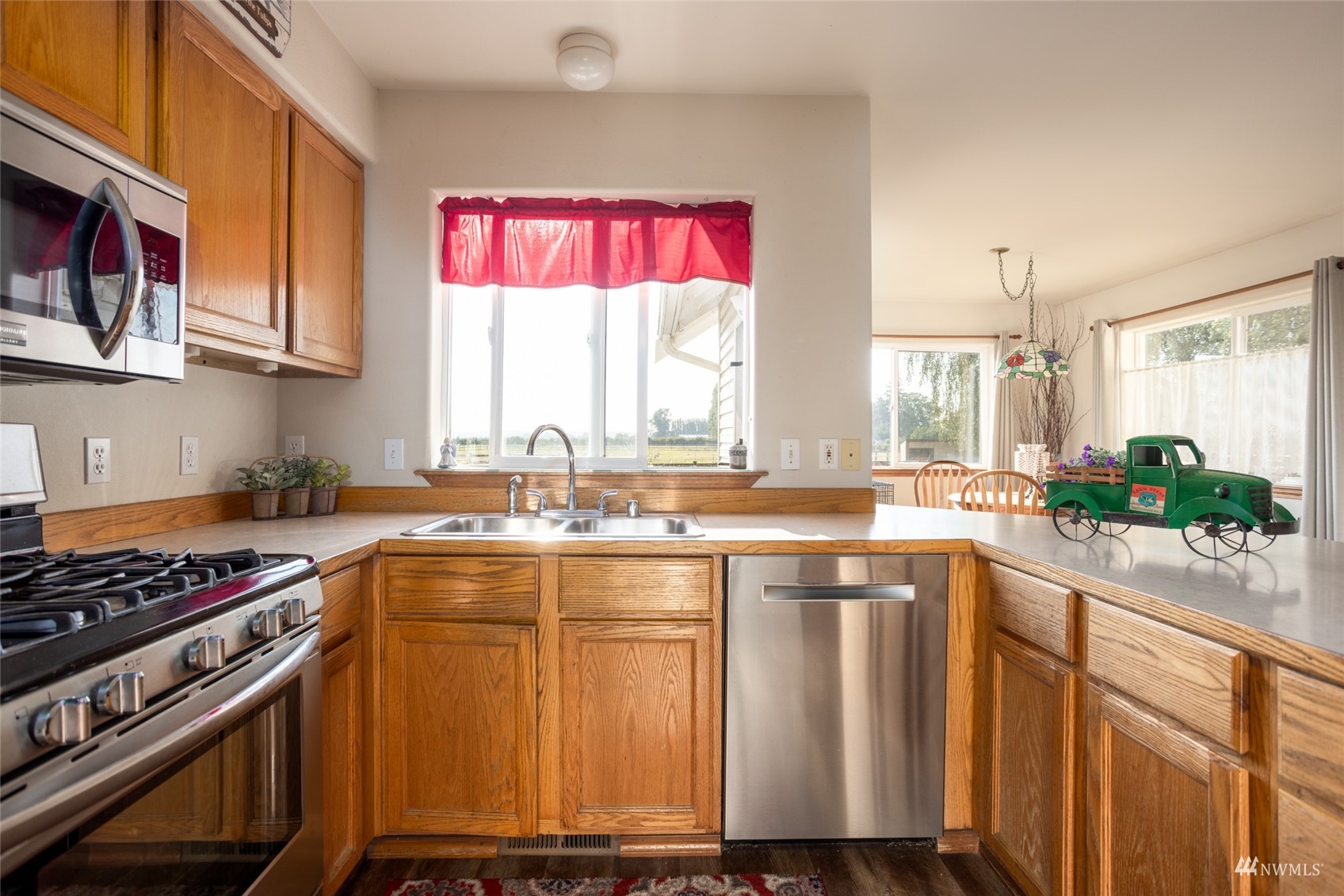 15606 Beaver Marsh Road Mount Vernon, WA 98273 - Photo 8 of 39 a kitchen with stainless steel appliances granite countertop a stove a sink and a microwave