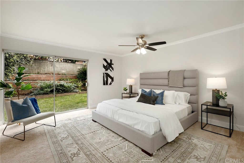 456 Castlegate Lane Brea, CA 92821 - Photo 23 of 40 Expansive Master Suite with crown molding, ceiling fan, and sliding door access to backyard