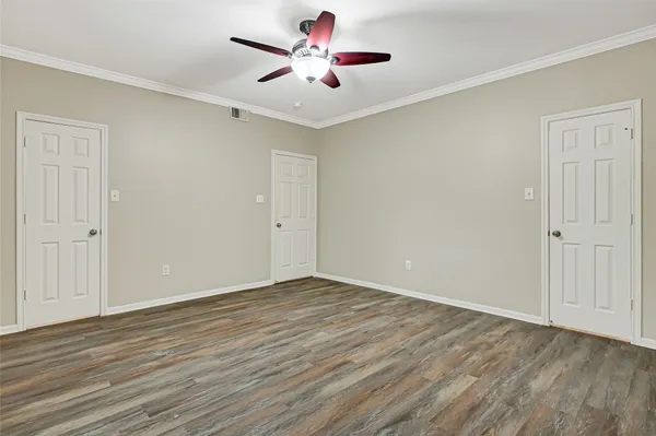 a view of walk in closet with empty racks