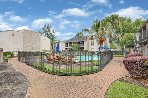 a view of a swimming pool with outdoor seating