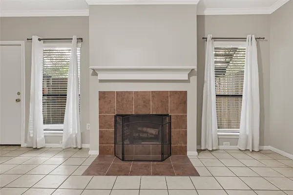 a view of an empty room with window and fireplace