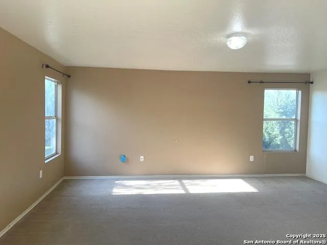 an empty room with windows and entrance