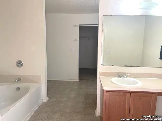 a bathroom with a bathtub and a sink
