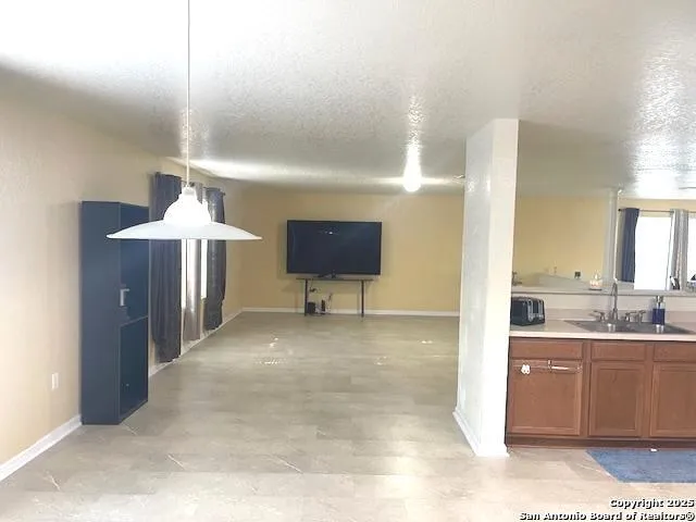 a view of a kitchen cabinets and chandelier