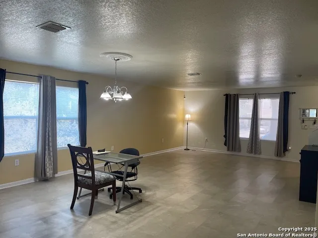 a view of a livingroom with furniture and chandelier