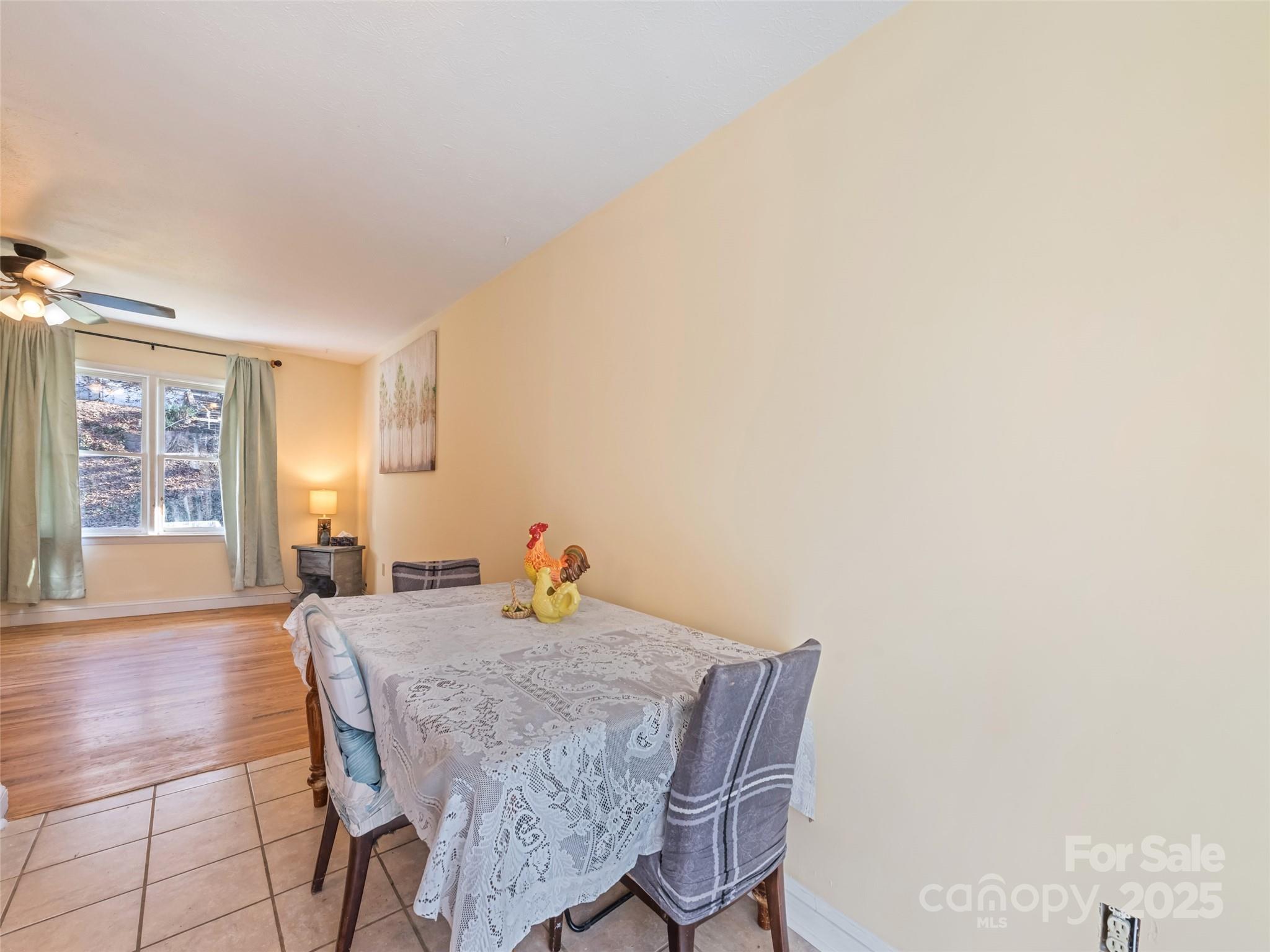 140 Oakdale Road Waynesville, NC 28786 - Photo 12 of 30 a view of a dining room with furniture and wooden floor
