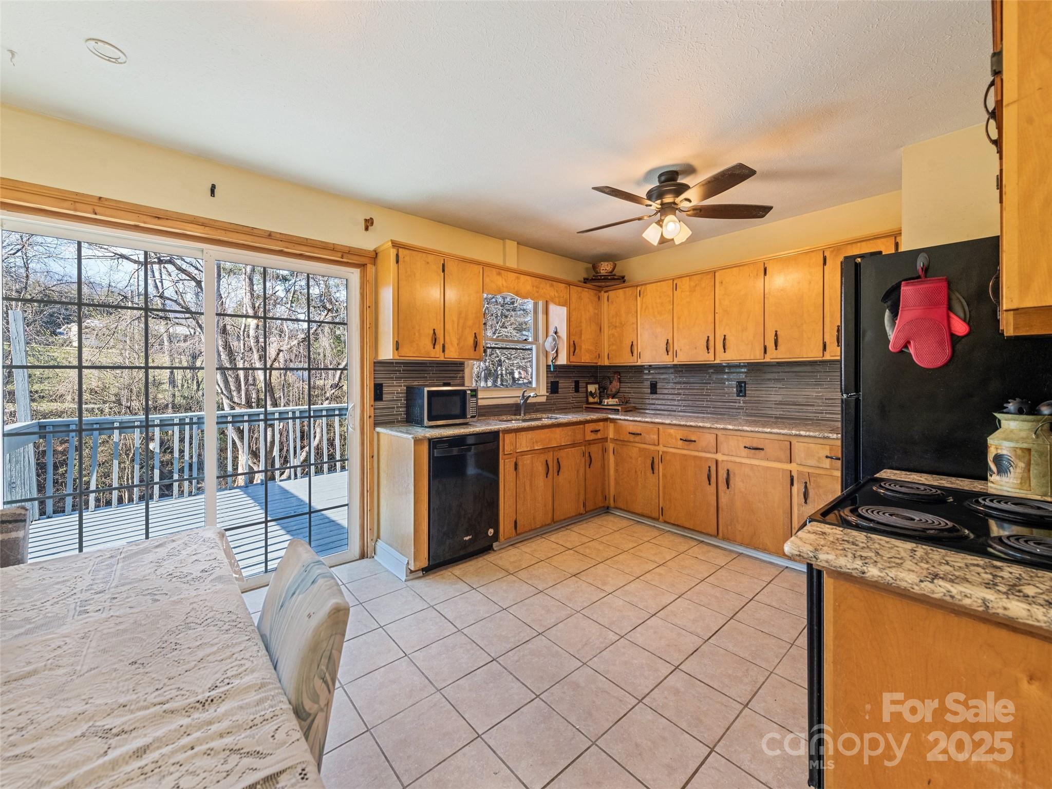 140 Oakdale Road Waynesville, NC 28786 - Photo 13 of 30 a kitchen with stainless steel appliances granite countertop a stove a sink and a refrigerator