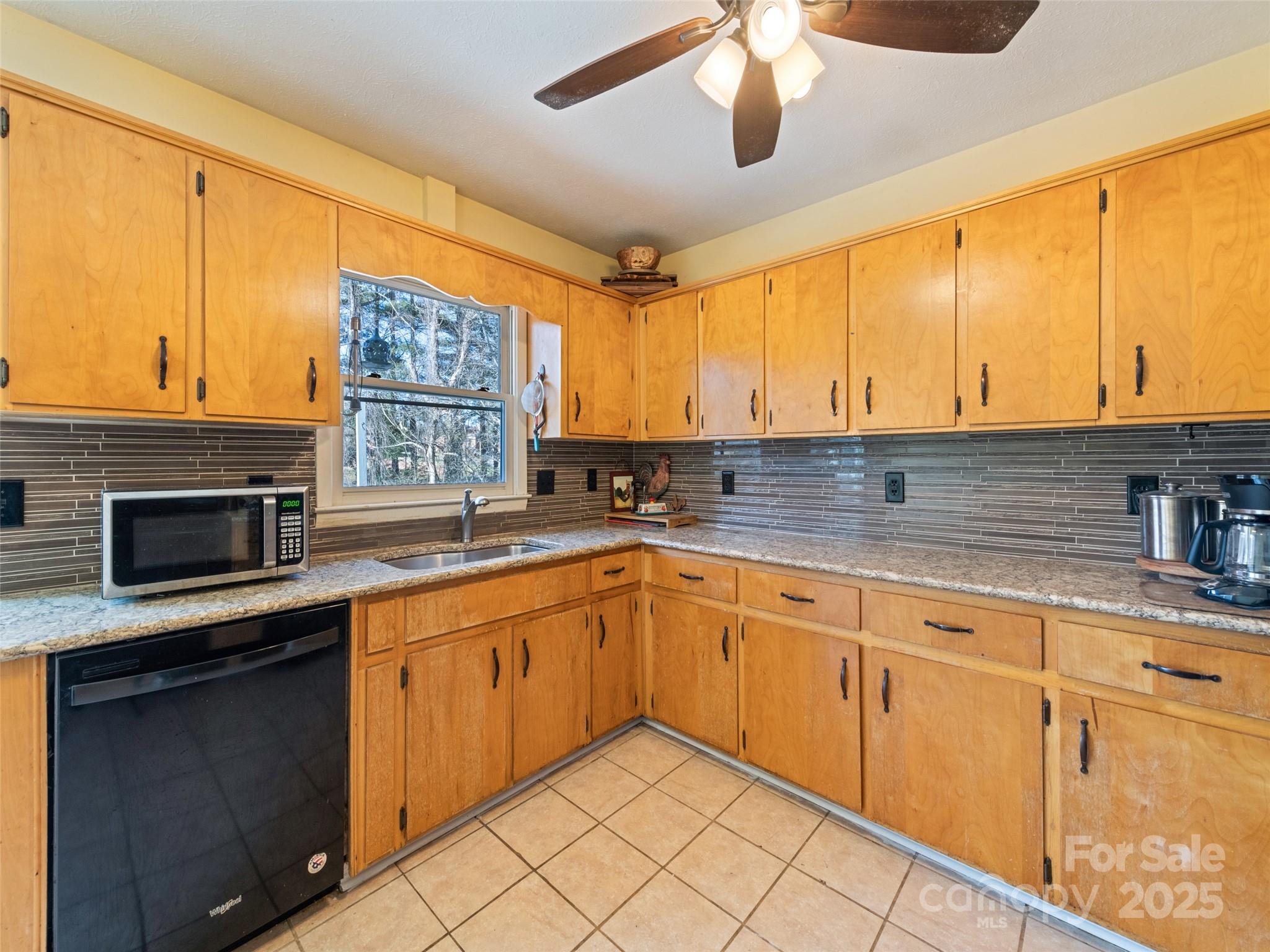 140 Oakdale Road Waynesville, NC 28786 - Photo 15 of 30 a kitchen with stainless steel appliances granite countertop a sink and cabinets