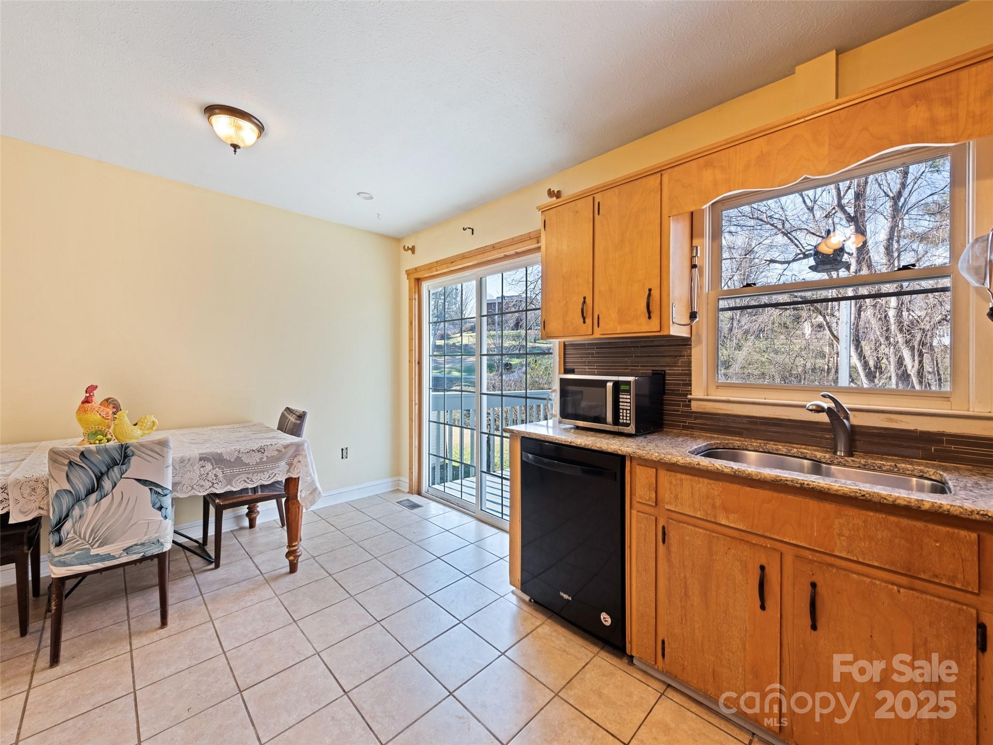 140 Oakdale Road Waynesville, NC 28786 - Photo 16 of 30 a kitchen with granite countertop a stove a sink and a microwave