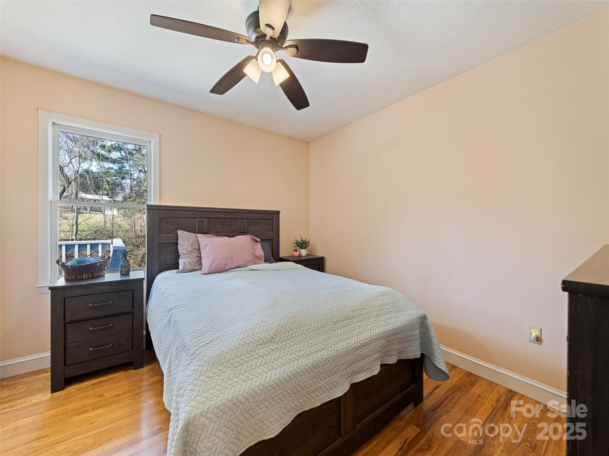 140 Oakdale Road Waynesville, NC 28786 - Photo 17 of 30 a bed sitting in a bedroom next to a window