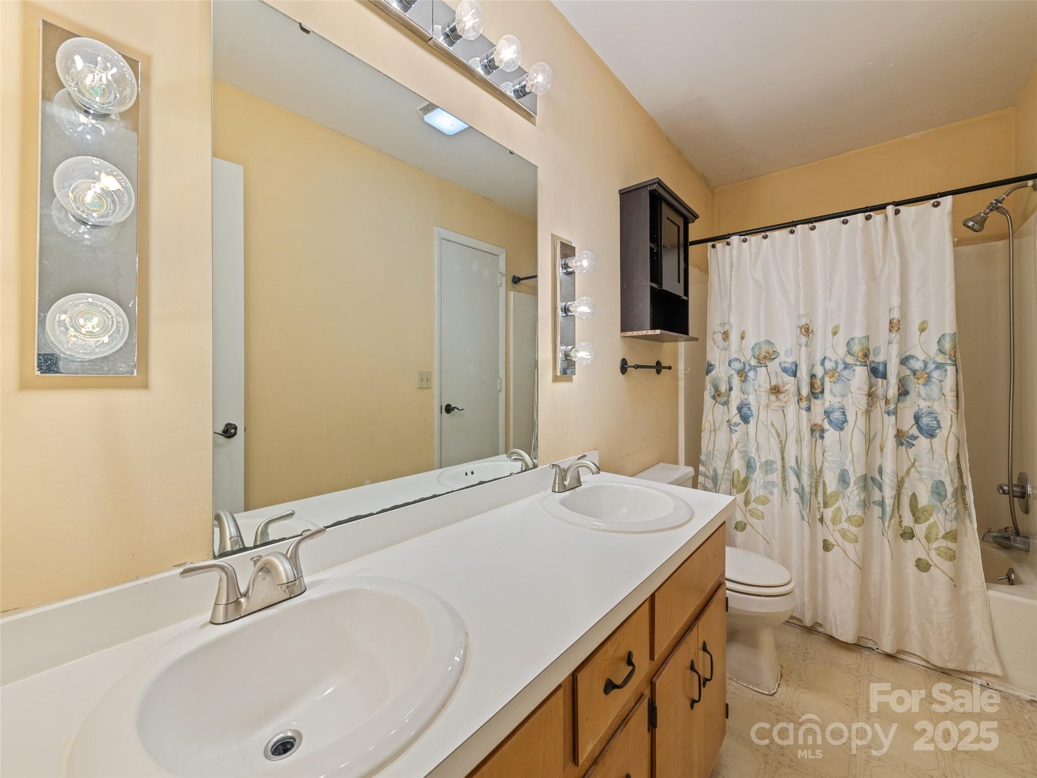 140 Oakdale Road Waynesville, NC 28786 - Photo 20 of 30 a bathroom with a sink and a mirror