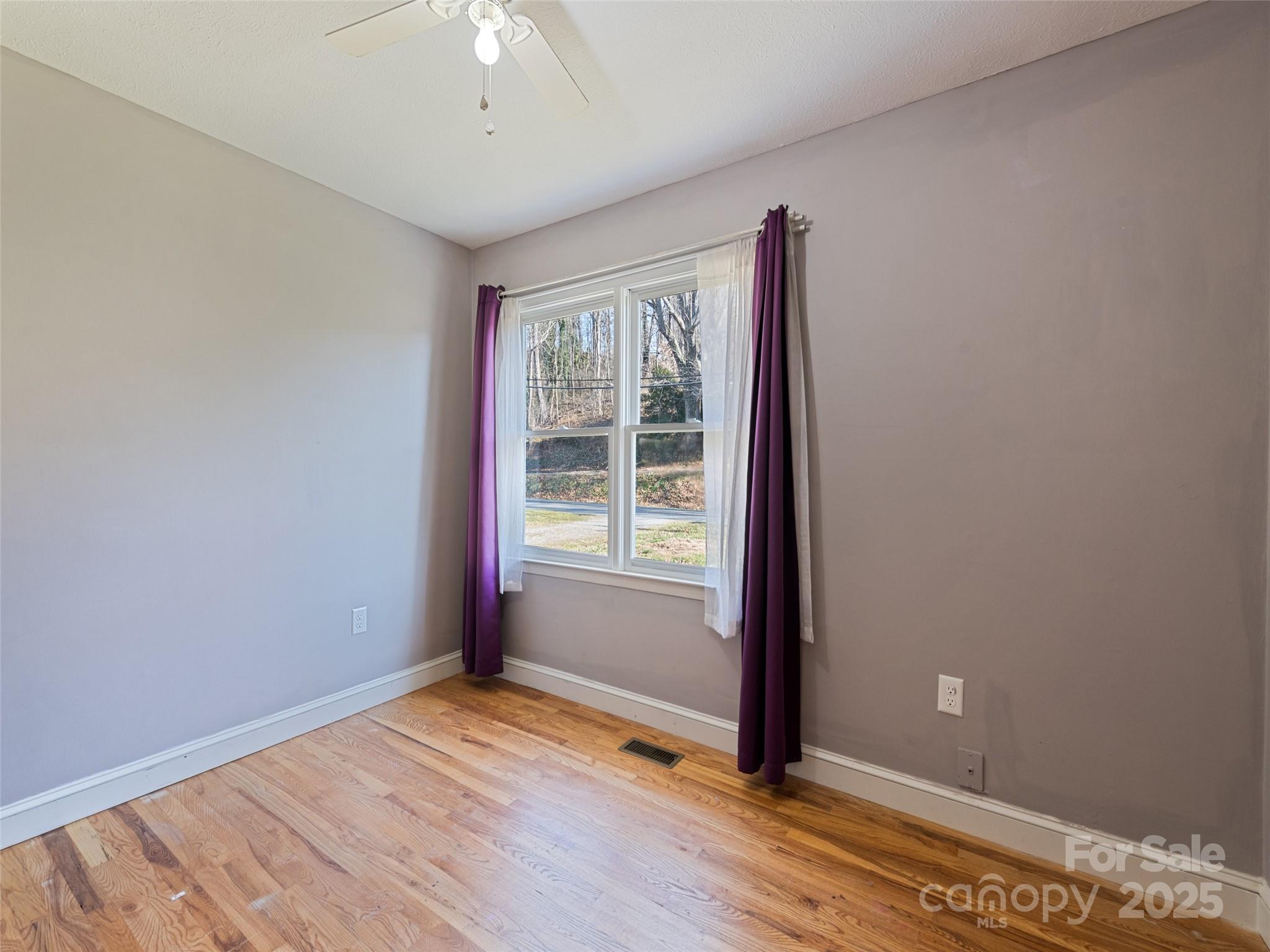 140 Oakdale Road Waynesville, NC 28786 - Photo 22 of 30 wooden floor and window in an empty room
