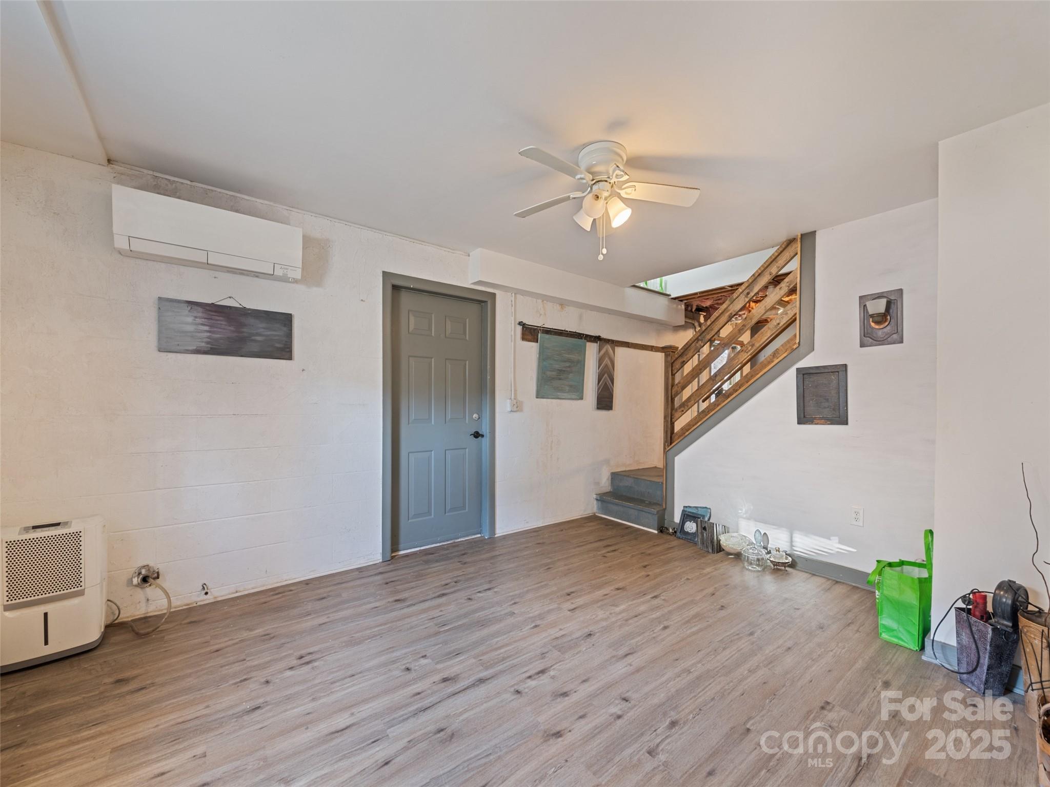 140 Oakdale Road Waynesville, NC 28786 - Photo 24 of 30 a view of empty room with wooden floor and fan