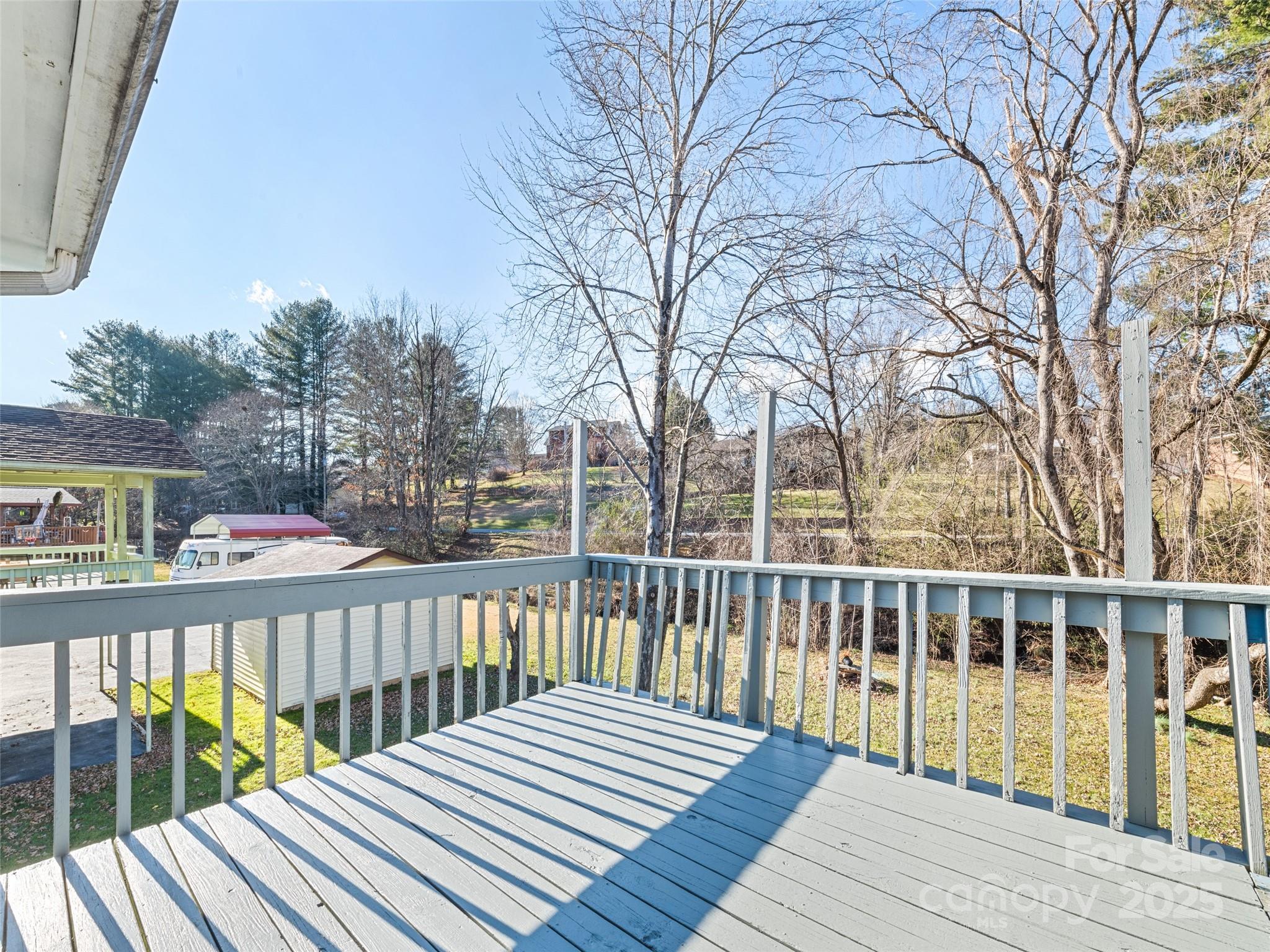 140 Oakdale Road Waynesville, NC 28786 - Photo 7 of 30 a view of wooden deck and a garden