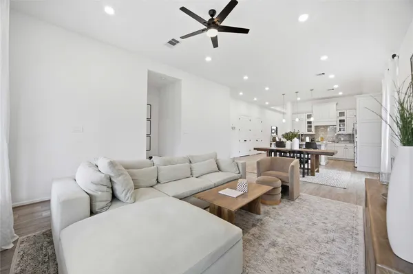 a living room with furniture and kitchen view
