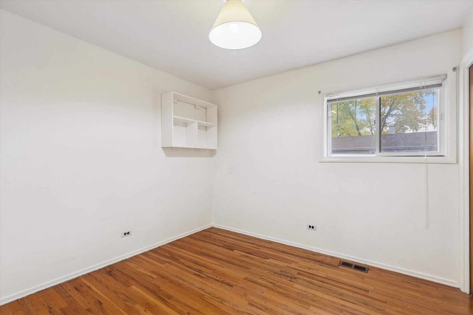 405 West Newport Road Hoffman Estates, IL 60169 - Photo 13 of 28 an empty room with wooden floor and windows