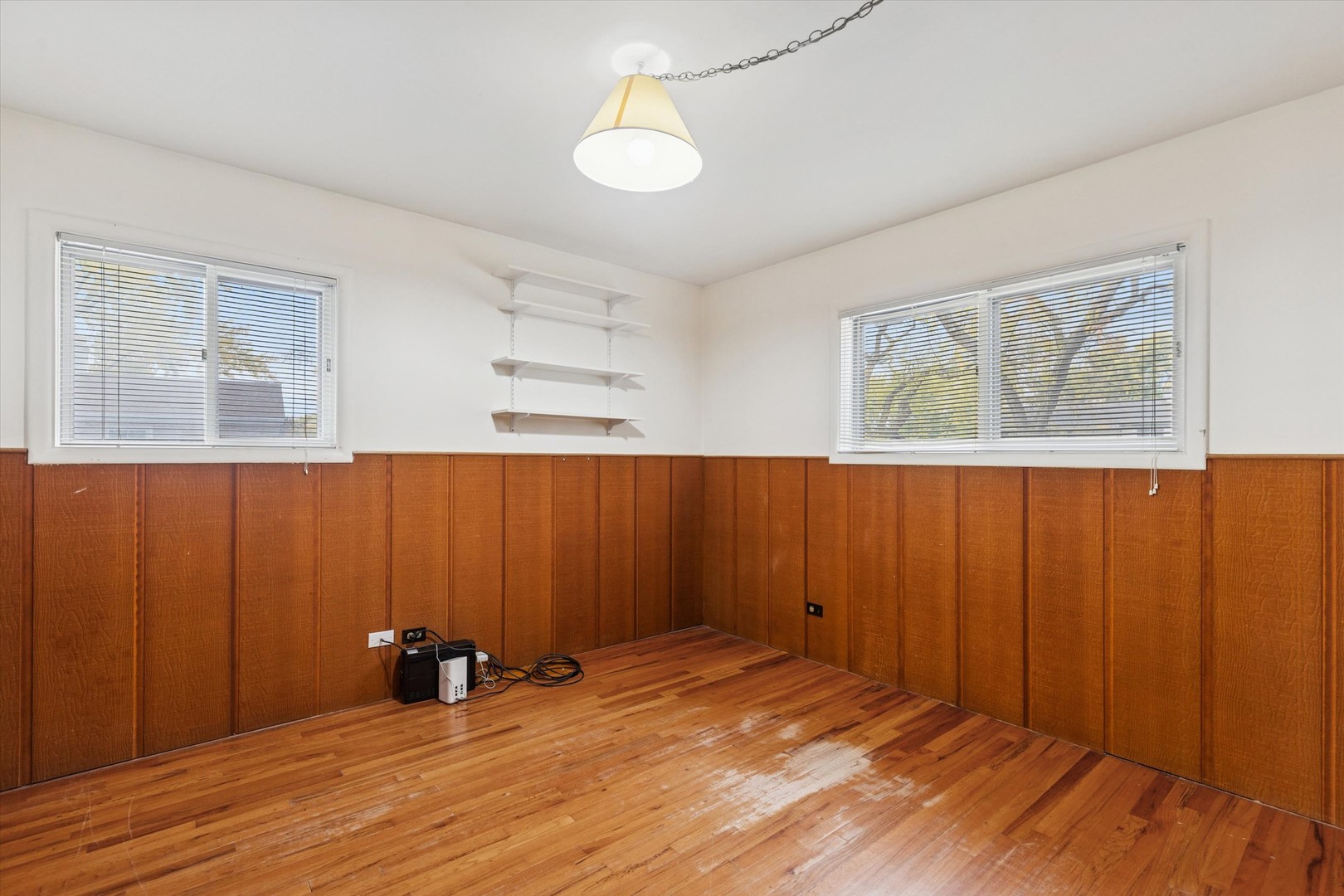 405 West Newport Road Hoffman Estates, IL 60169 - Photo 14 of 28 a view of an empty room with wooden floor and a window