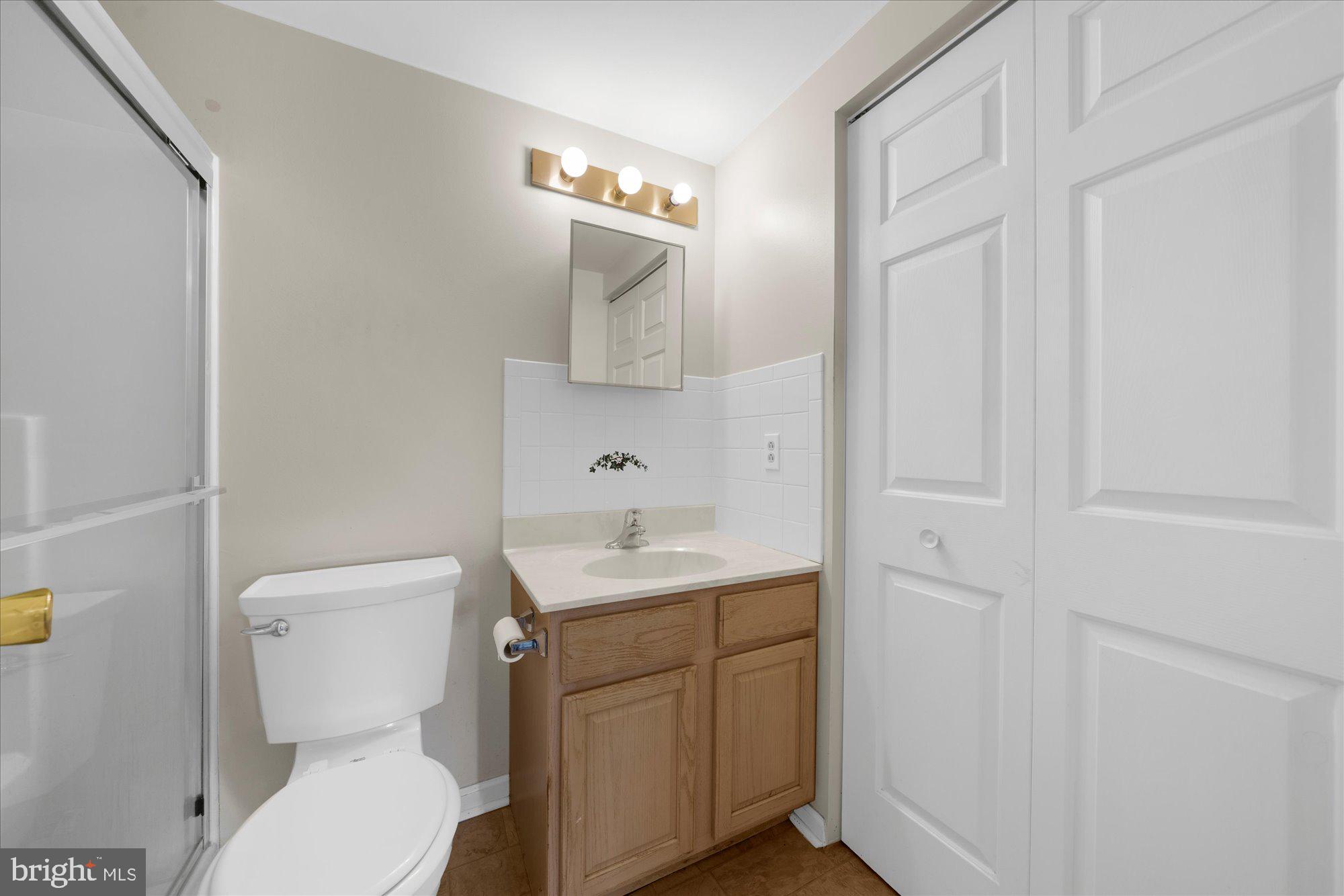 112 Brandon Road Eagleville, PA 19403 - Photo 19 of 19 a bathroom with a toilet a sink and mirror