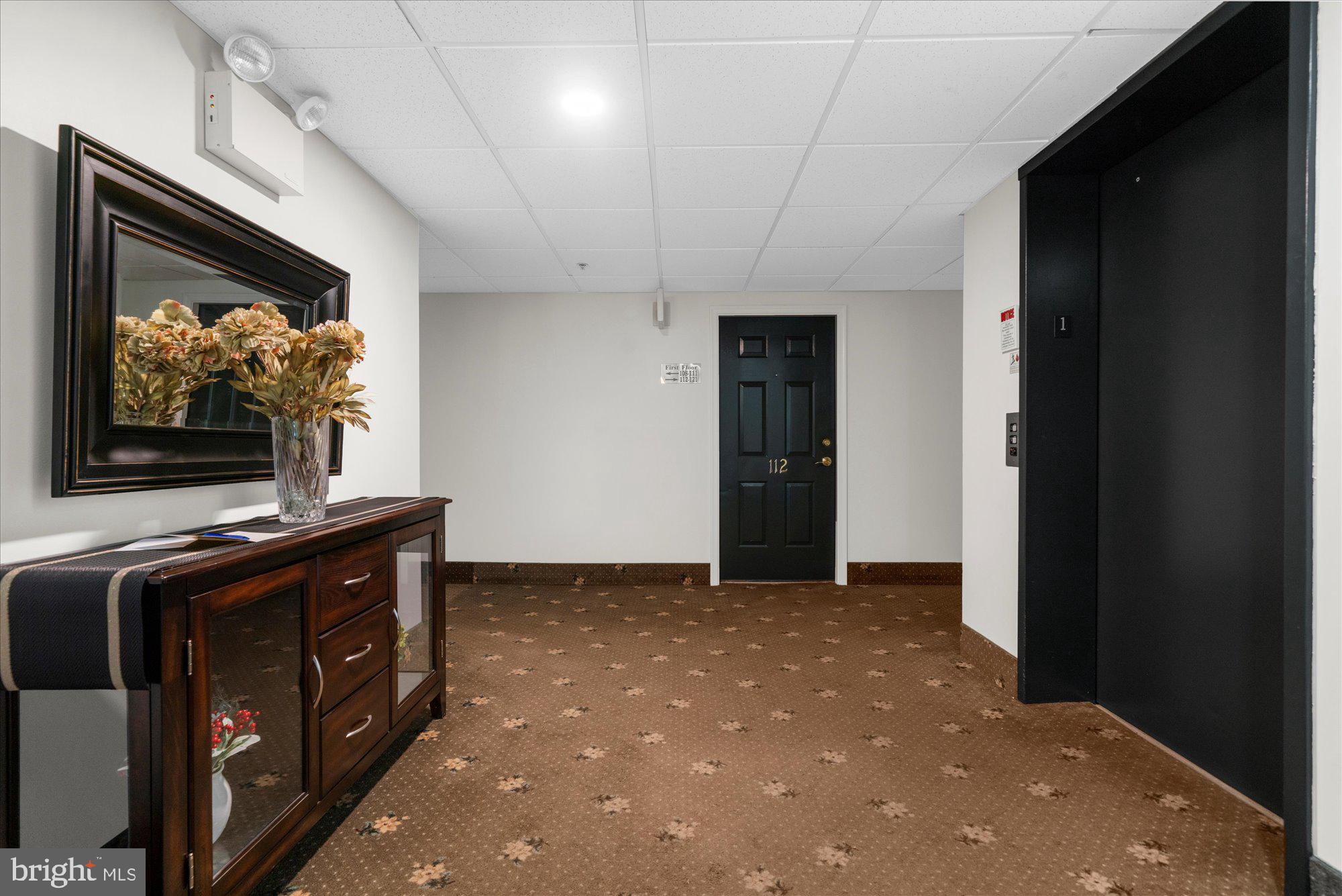112 Brandon Road Eagleville, PA 19403 - Photo 4 of 19 a living room with a flat screen tv a washer and dryer