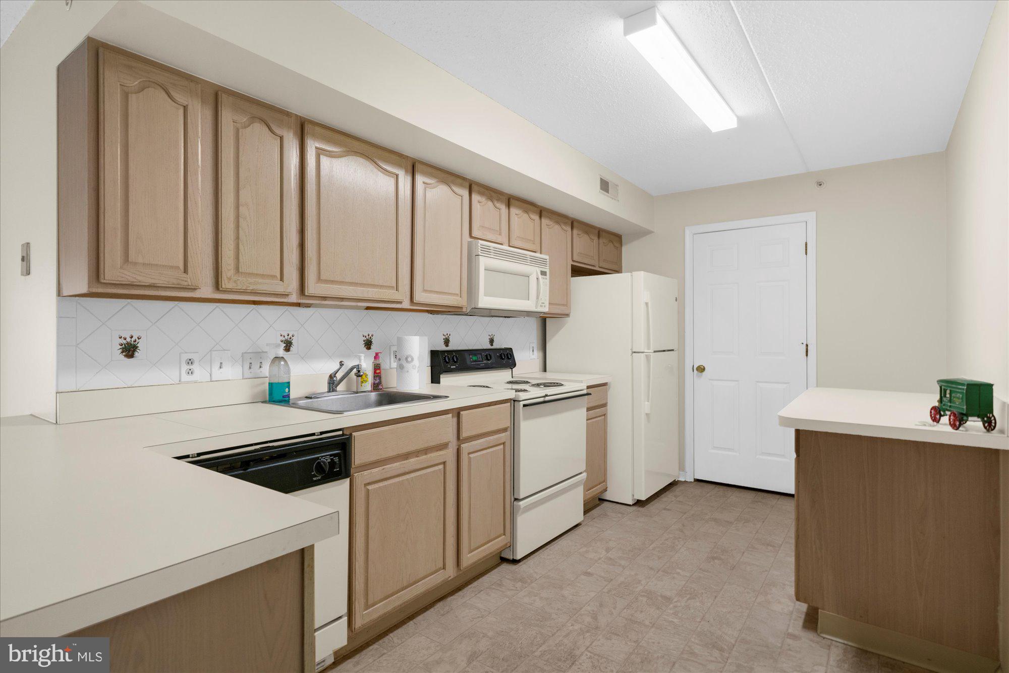 112 Brandon Road Eagleville, PA 19403 - Photo 6 of 19 a kitchen with sink a microwave and cabinets