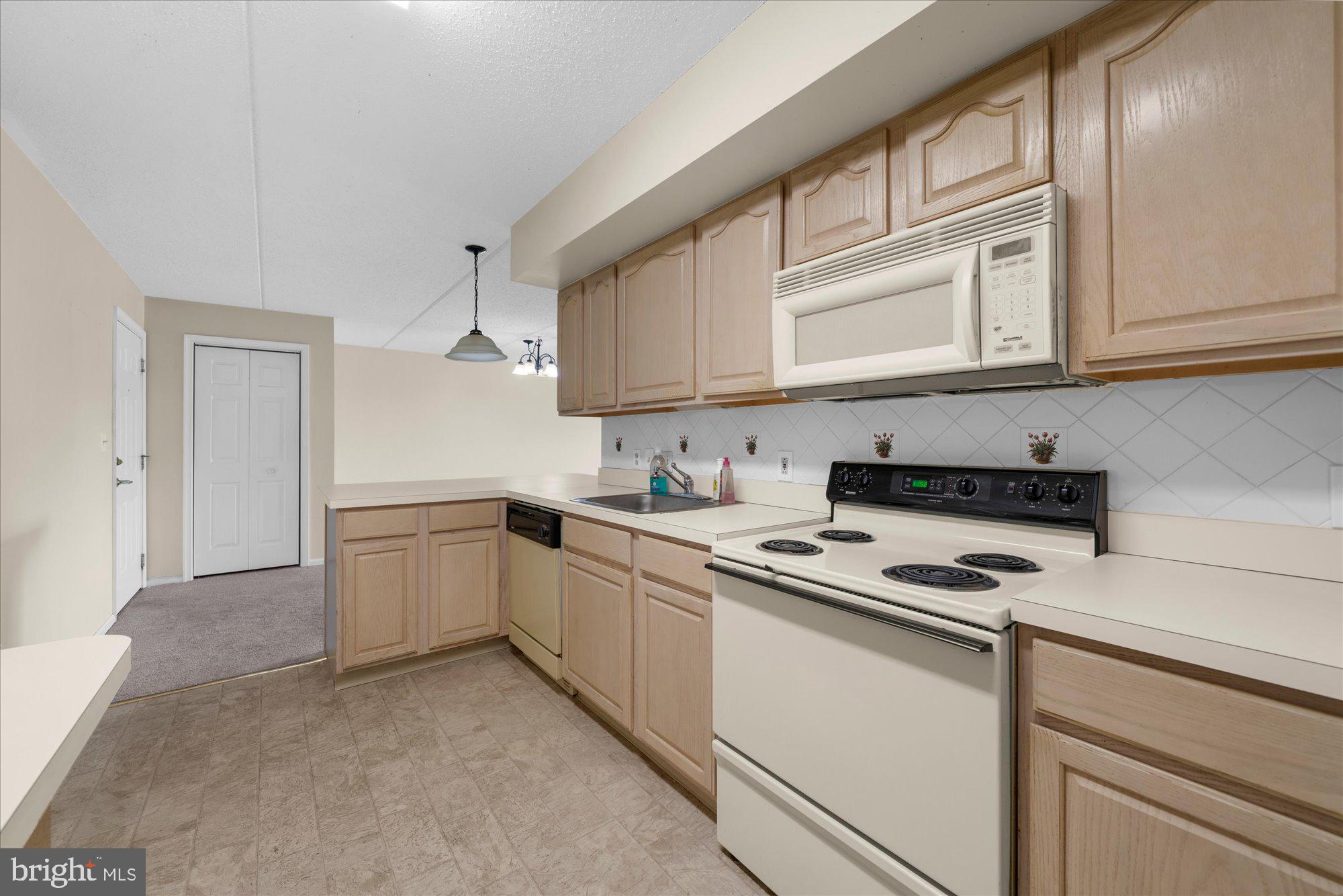 112 Brandon Road Eagleville, PA 19403 - Photo 7 of 19 a kitchen with cabinets appliances a sink and a window