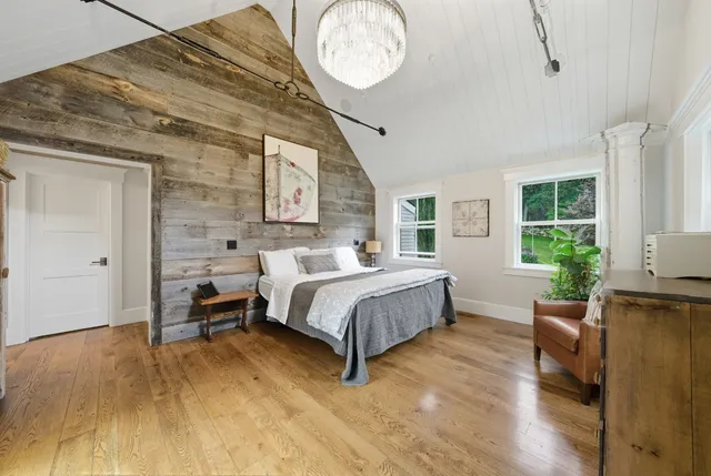 a spacious bedroom with a bed closet and a large window